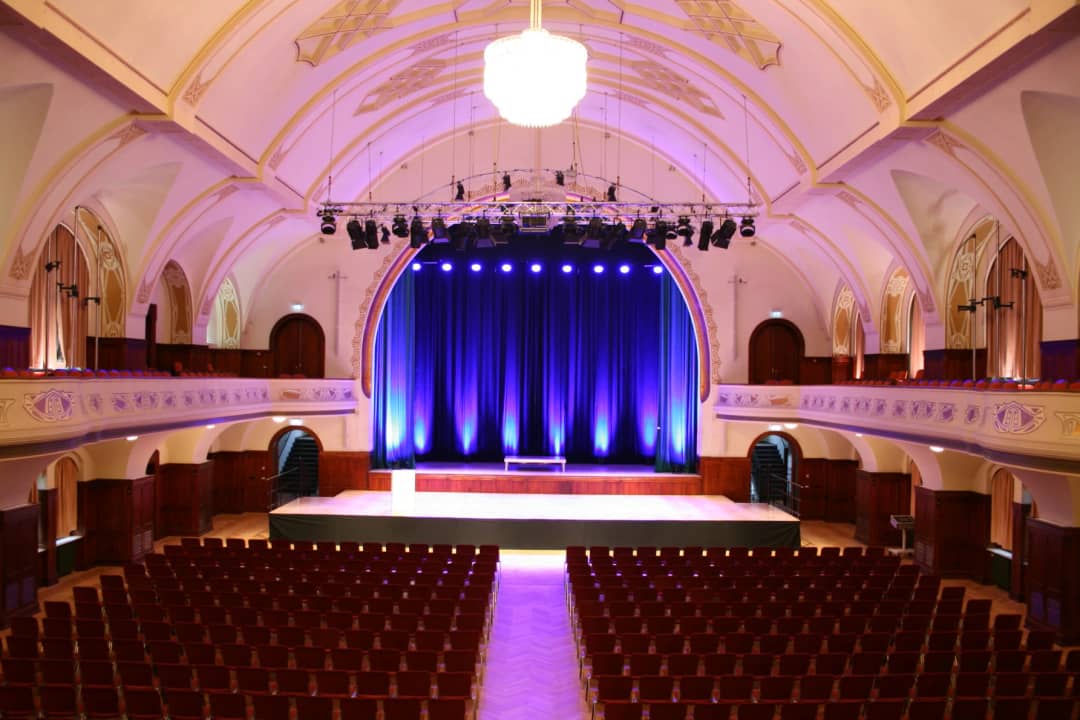 Hall of the Volkshaus Jena with stage, curtain and seating