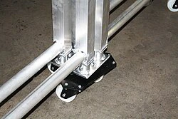Trapeze roller under a rollable stage